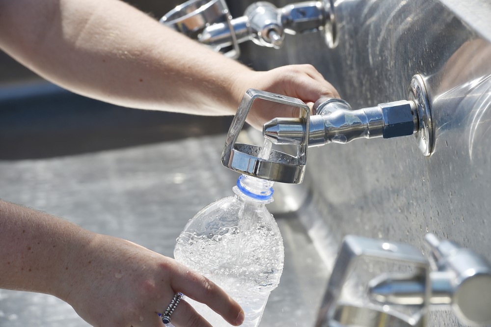 filling transparent water bottle