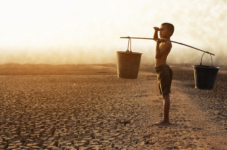 small boy taking water buckets in hand