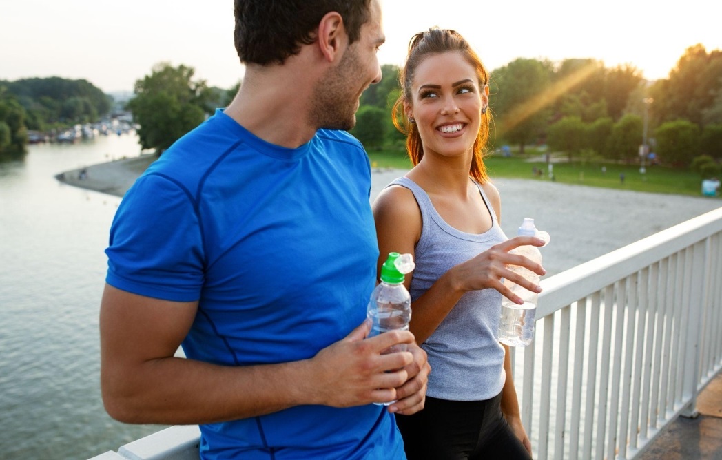 Couple resting after exercising, drinking water
