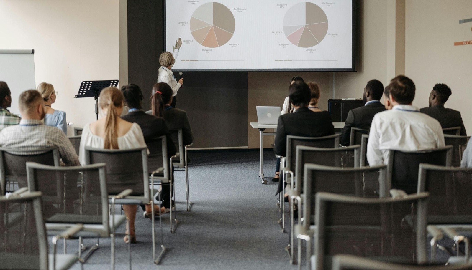 Group of people watching a presenter at a business conference